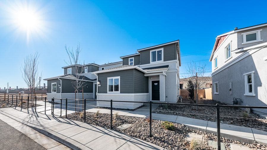 Exterior of the Saguaro model home in Phoenix, a two-story home with a combination of charcoal gray, horizontal-plank siding and stucco with a covered front entryway.