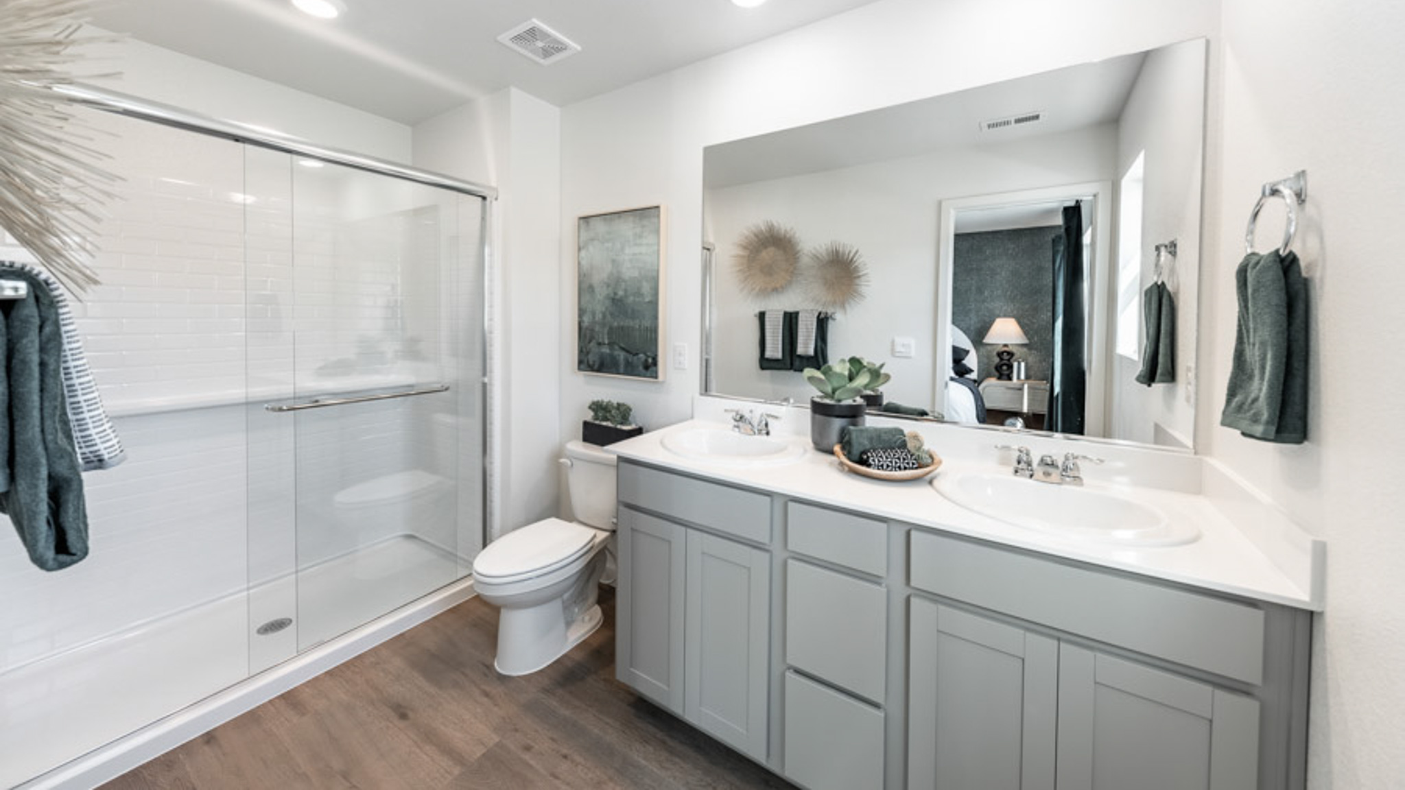 Primary bathroom with a vanity and large walk in shower
