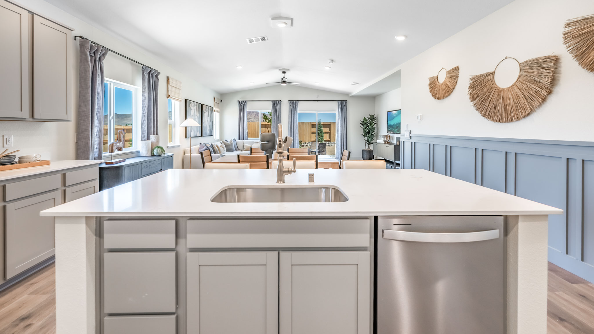 Large island with sink in the middle with a dishwasher