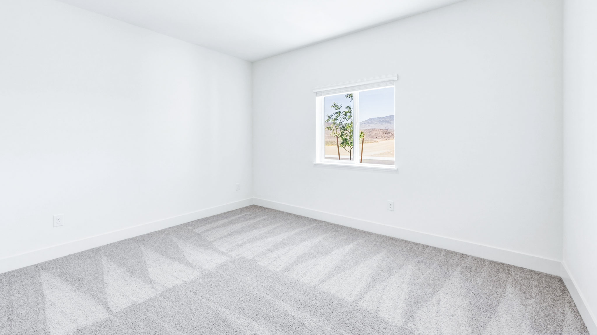 Secondary carpeted bedroom with bright light