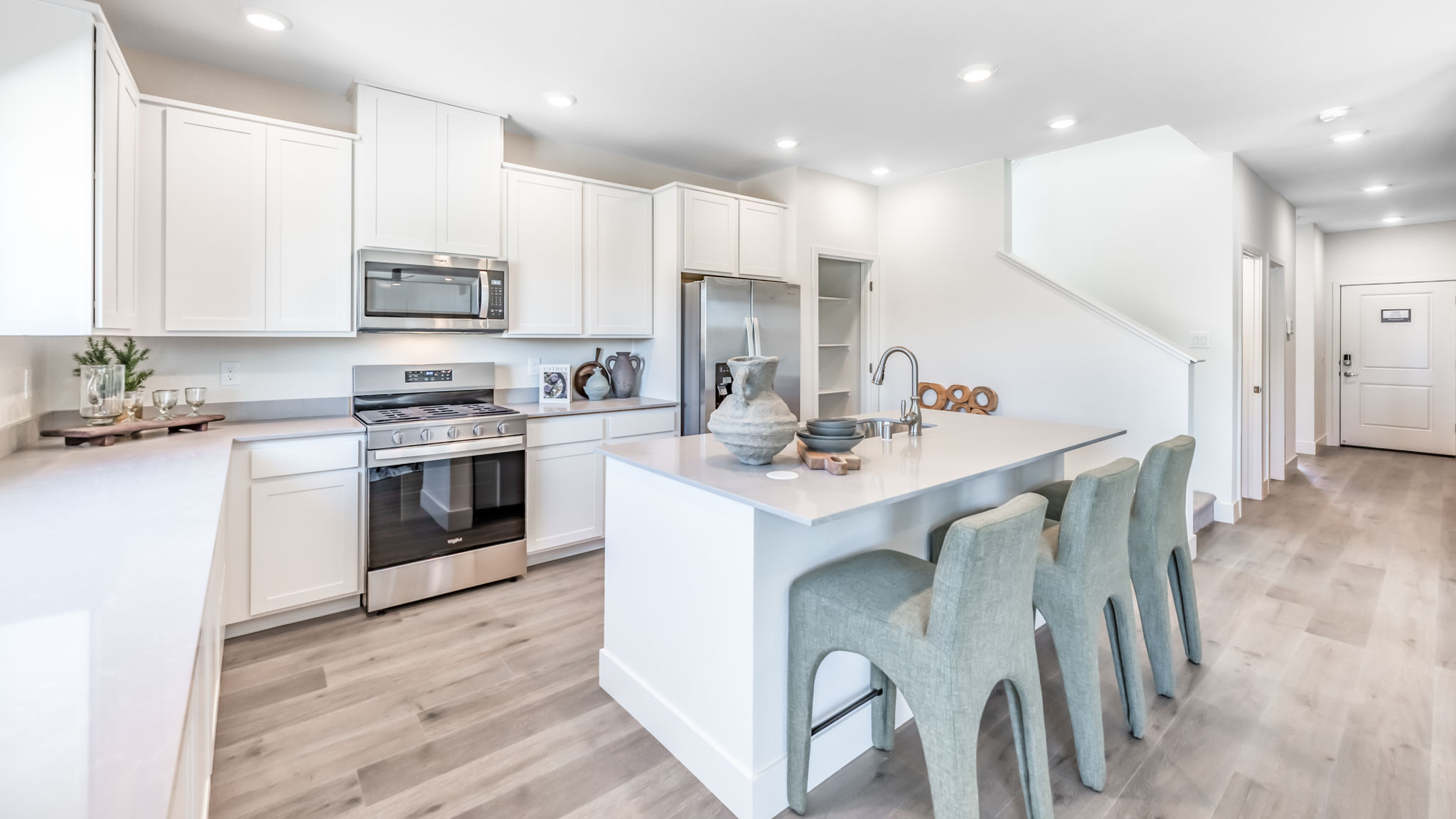Bright modern kitchen with island and large pantry