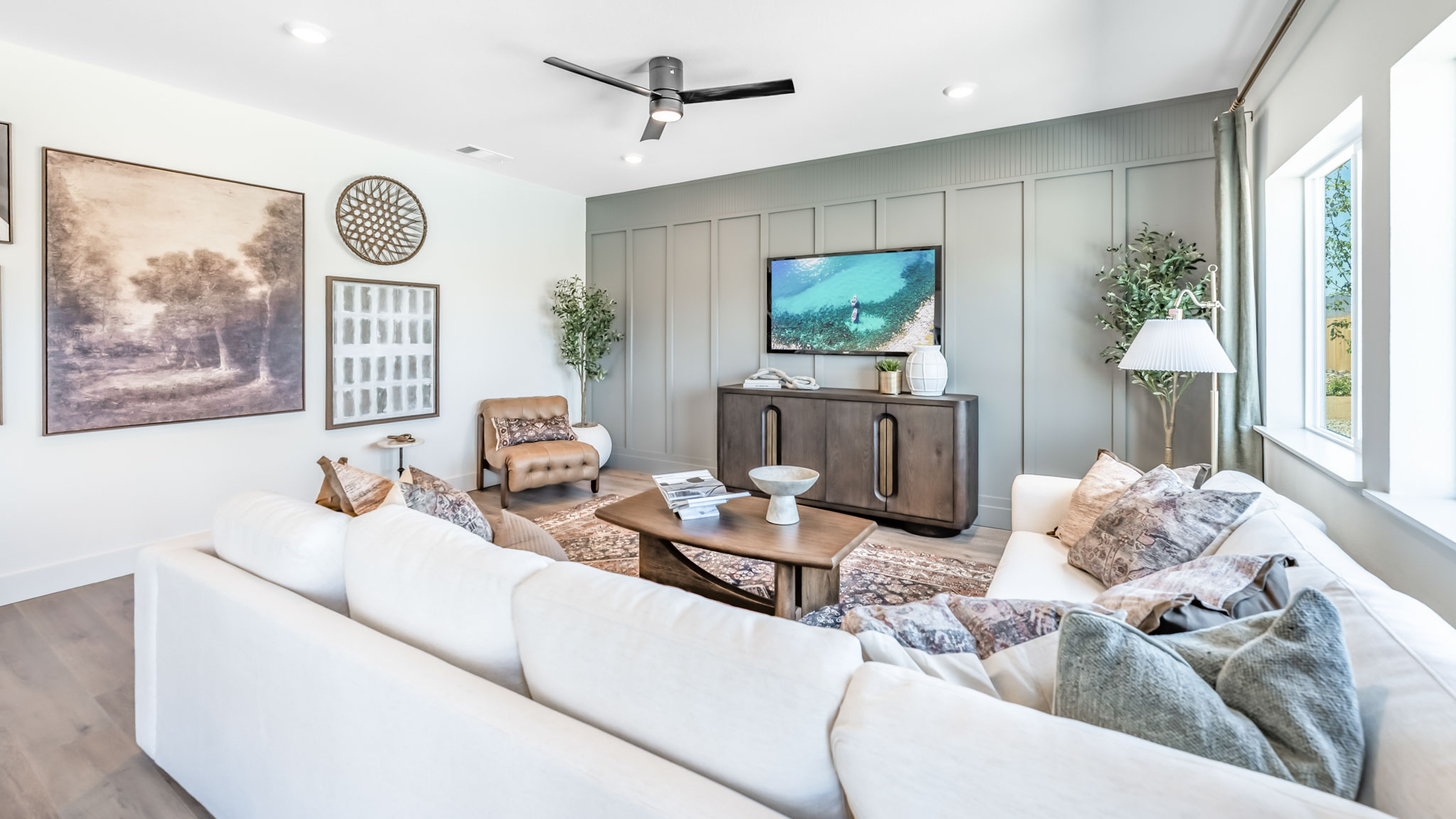Living room with space for a large sectional couch and large bright windows