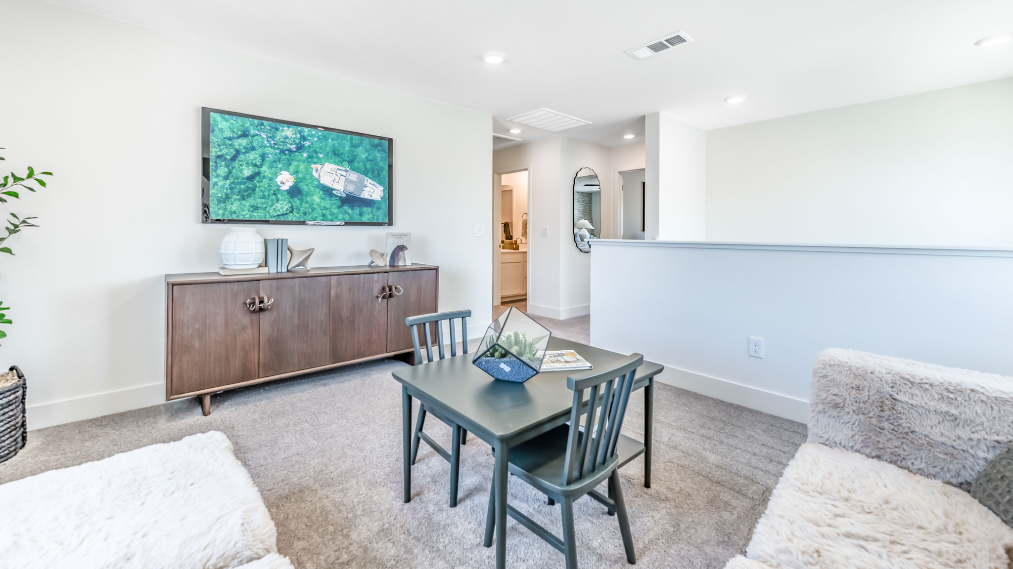 A desk and a large sectional in the loft area