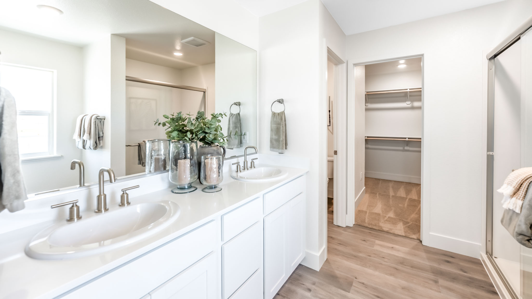 Large primary bathroom with walk-in shower and large walk-in closet