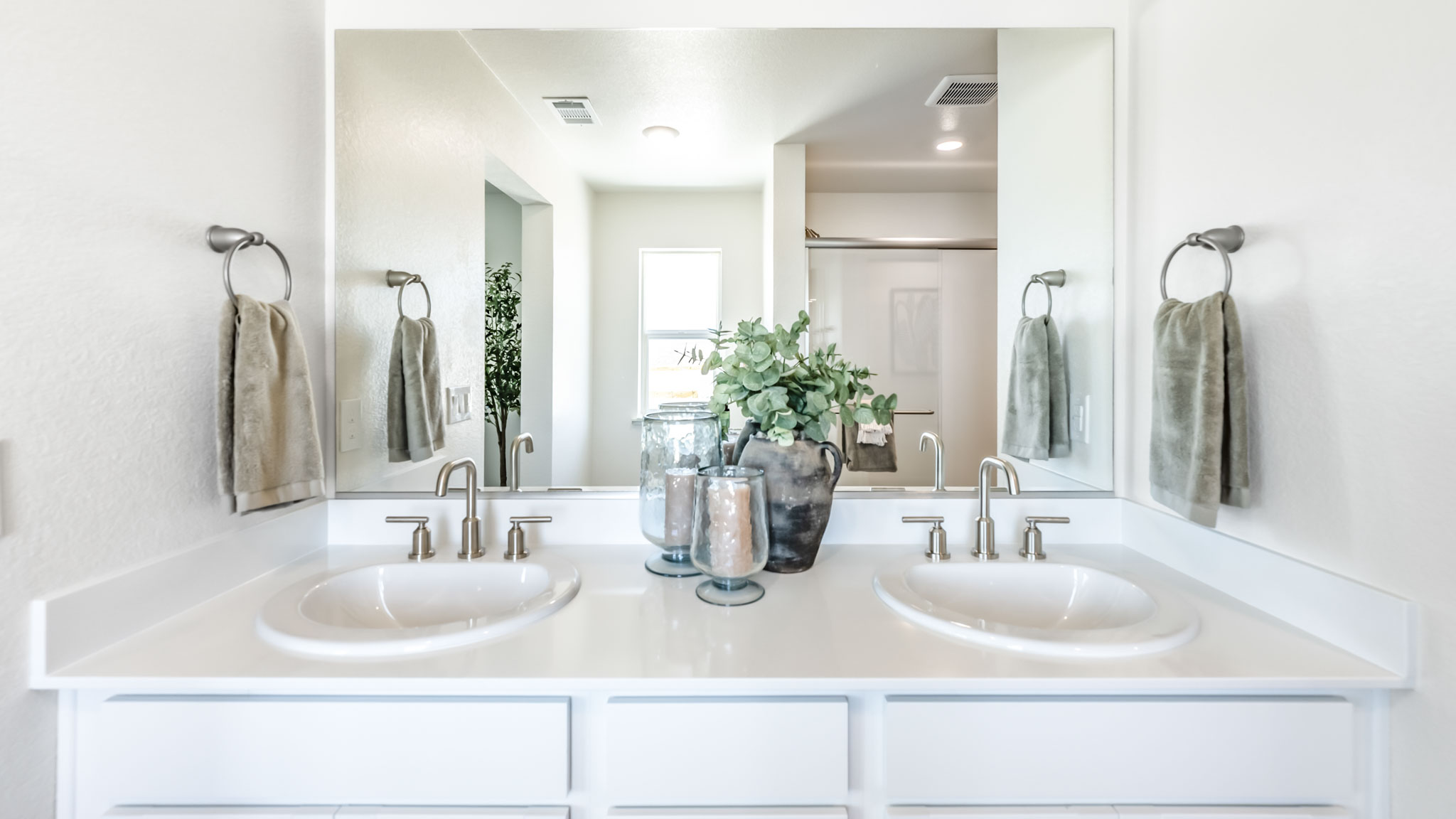 Double vanity in primary bathroom with built-in mirror