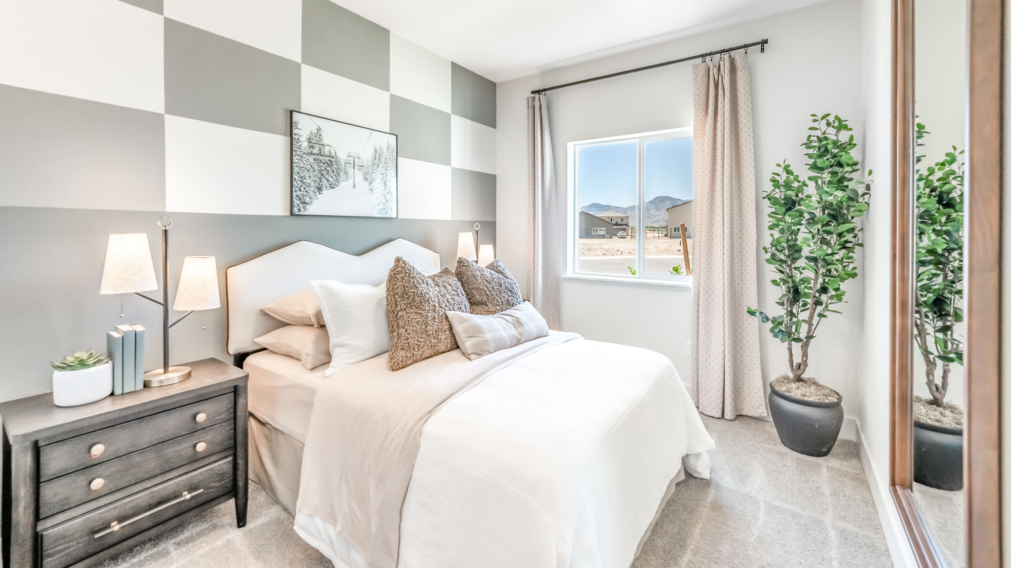 Bedroom on the first floor on the home with large window letting in natural light