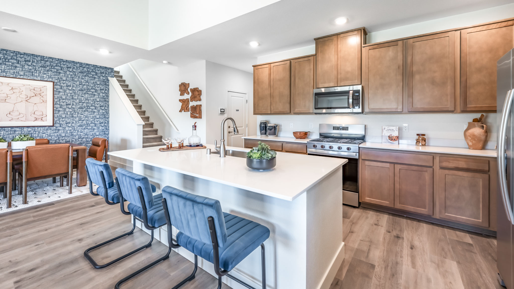 Bright modern kitchen with island and stainless steel appliances