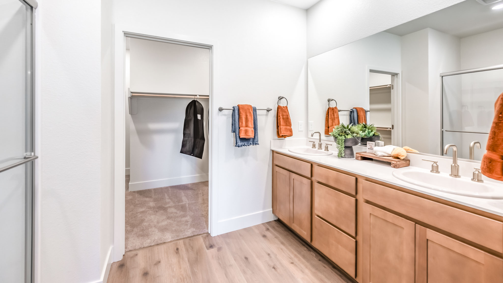 Large primary bathroom with walk-in shower and large walk-in closet