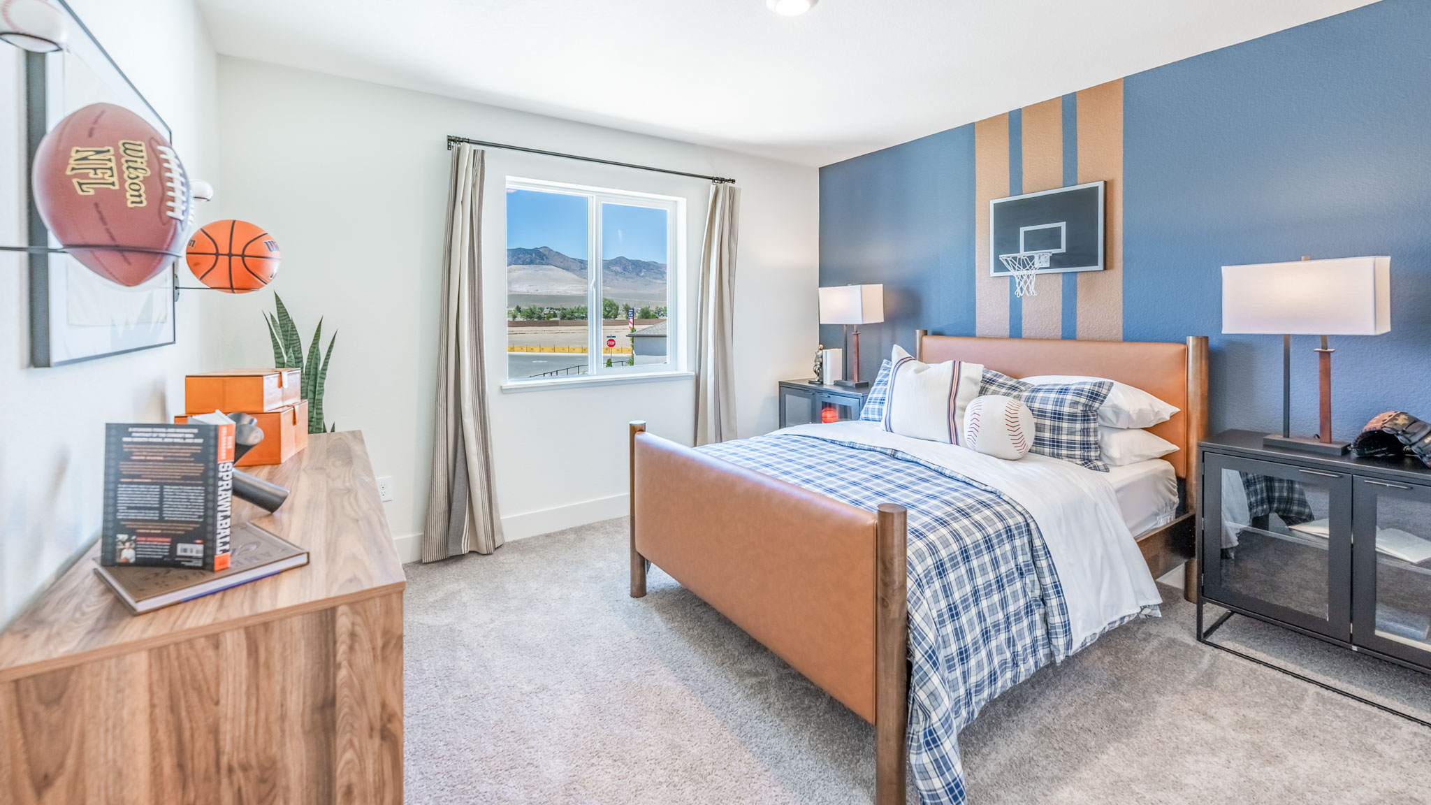 Kid's bedroom with carpet and large window letting in bright light