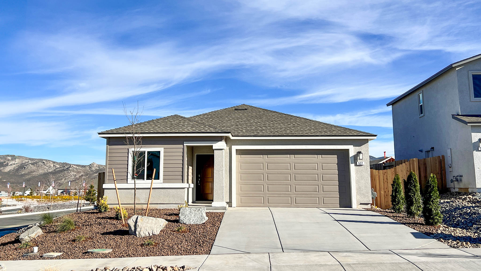 Single-story Carlsbad floorplan with stucco exterior and green accents