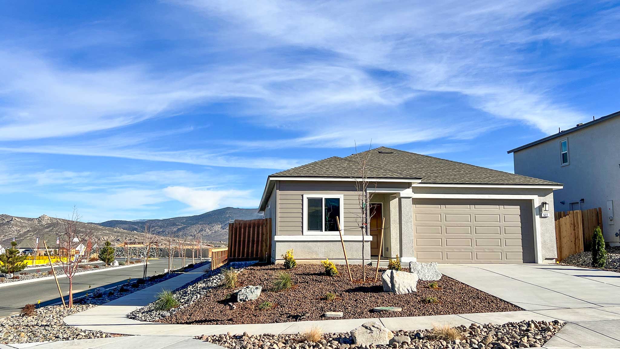 Single-story Carlsbad floorplan with stucco exterior and green accents