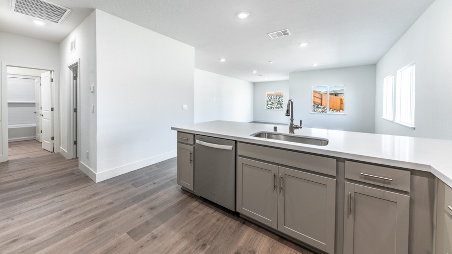 Modern kitchen with stainless steel appliances and L shaped island