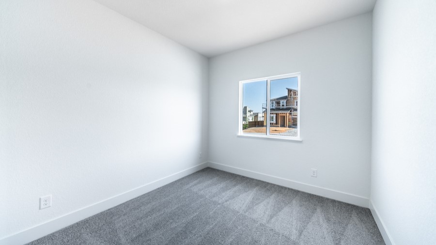 Secondary bedroom with carpeted floors