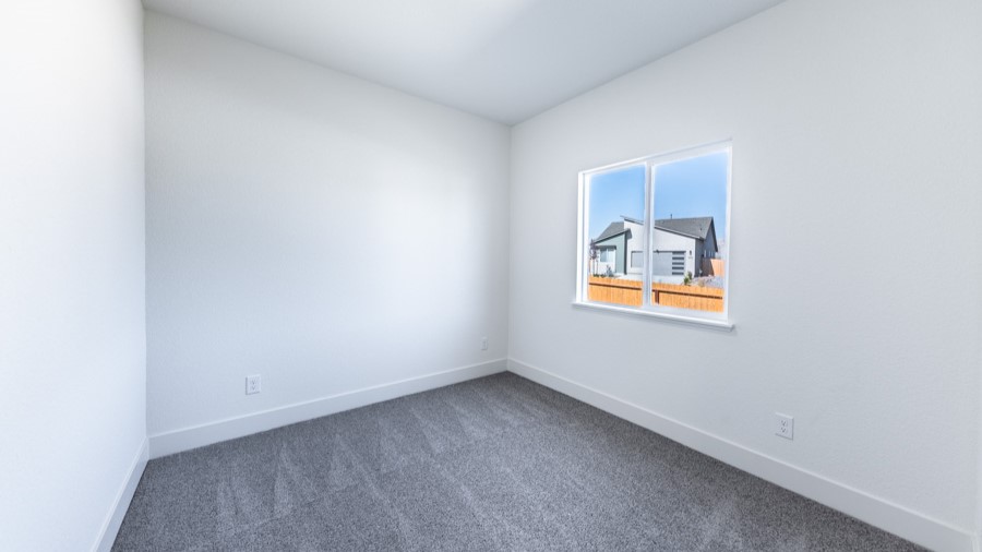 Secondary bedroom with carpeted floors