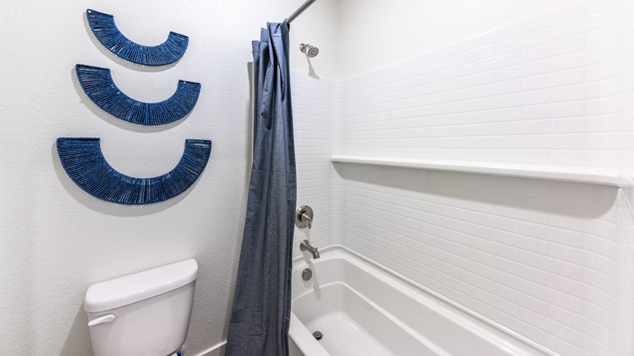 Secondary bathroom with bathtub and shower combo and toilet
