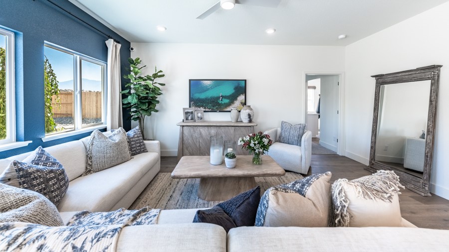 Large living area with a large window and room for a sectional couch