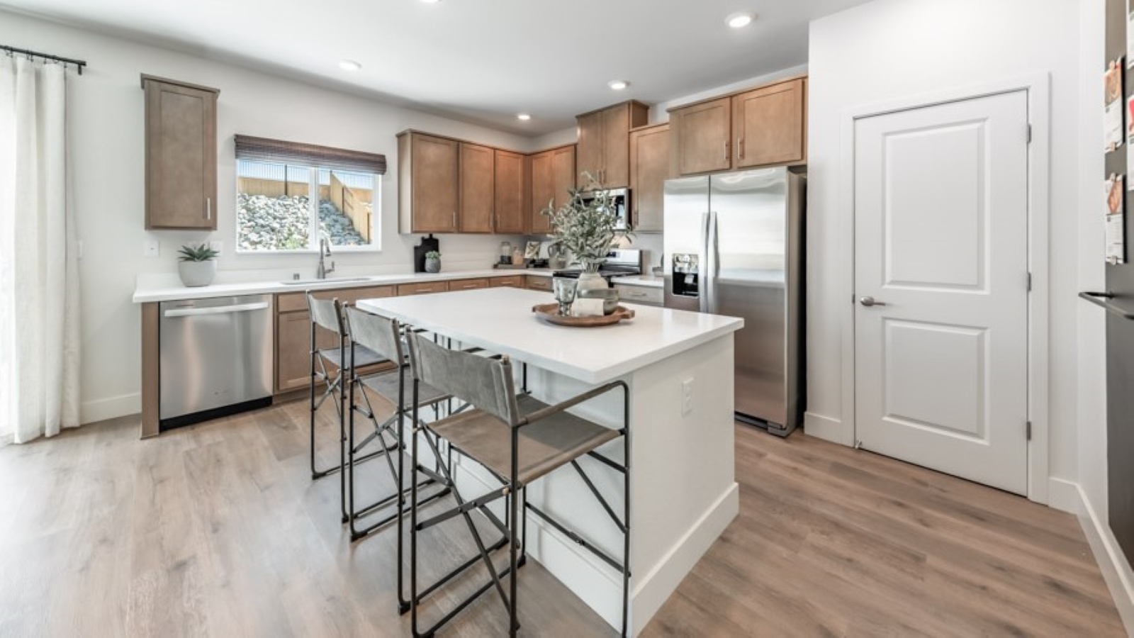 Bright open kitchen with window above the sink and an island
