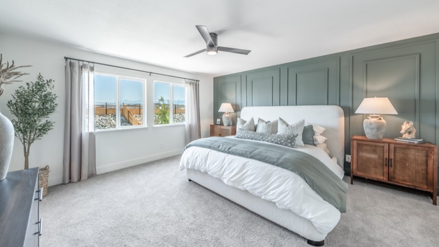 Large primary bedroom with large windows letting in plenty of natural light