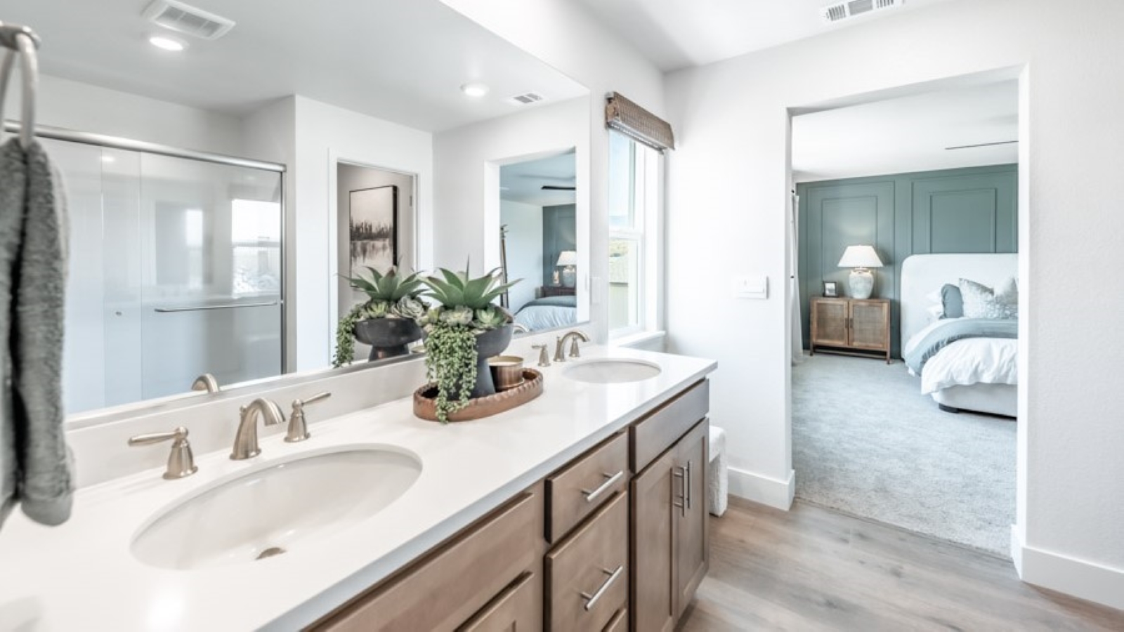 Walk-in shower in the primary bathroom next to large walk-in closet
