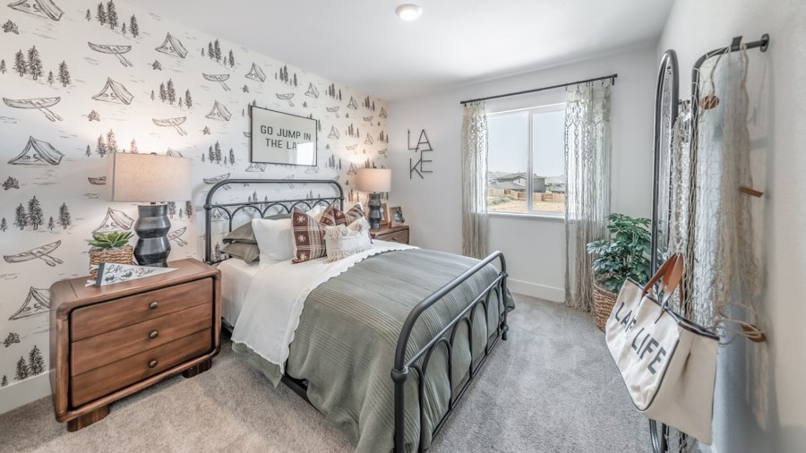 Secondary bedroom with a large window and carpeted floors