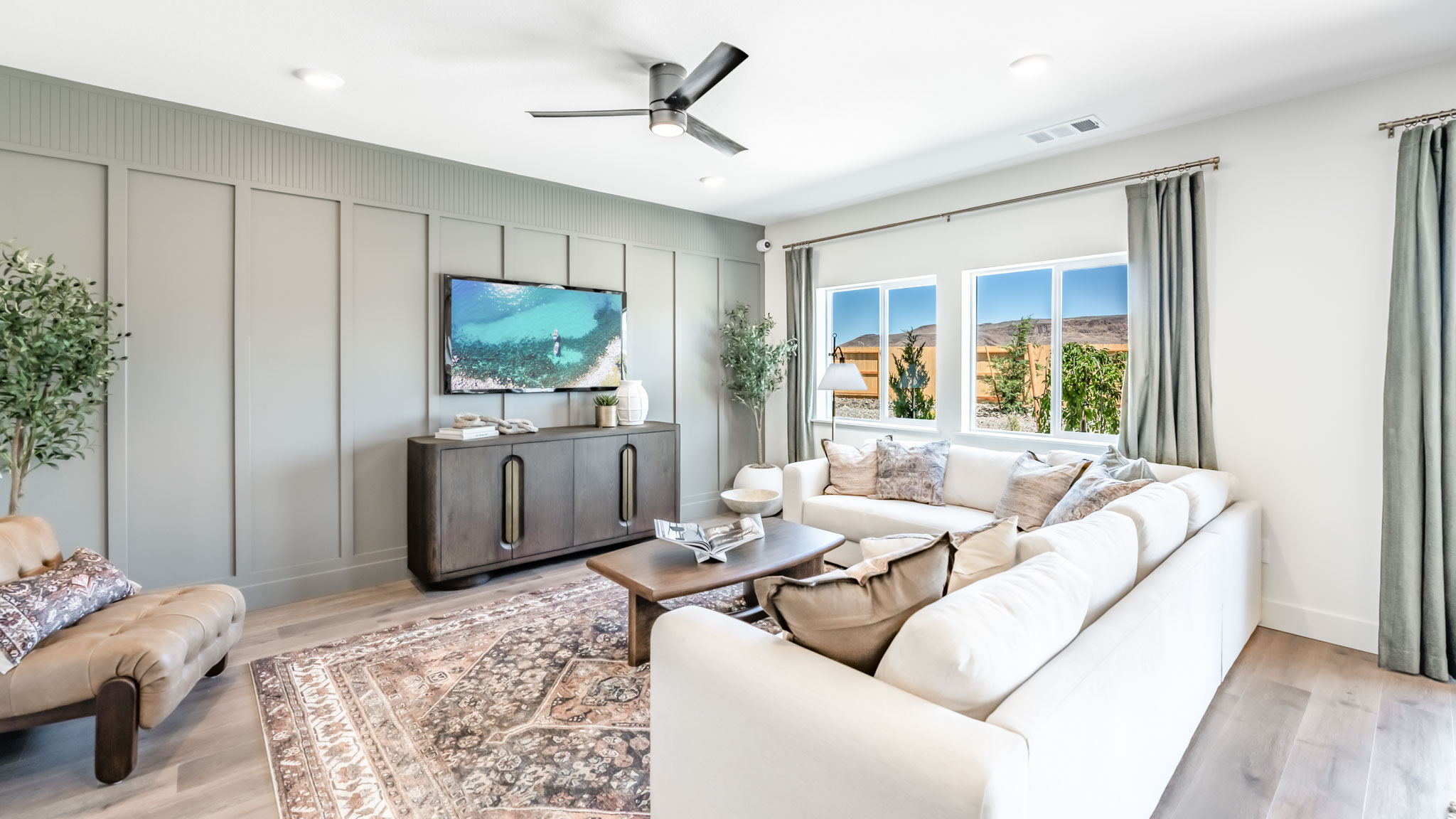 Modern living room with windows looking out into back yard