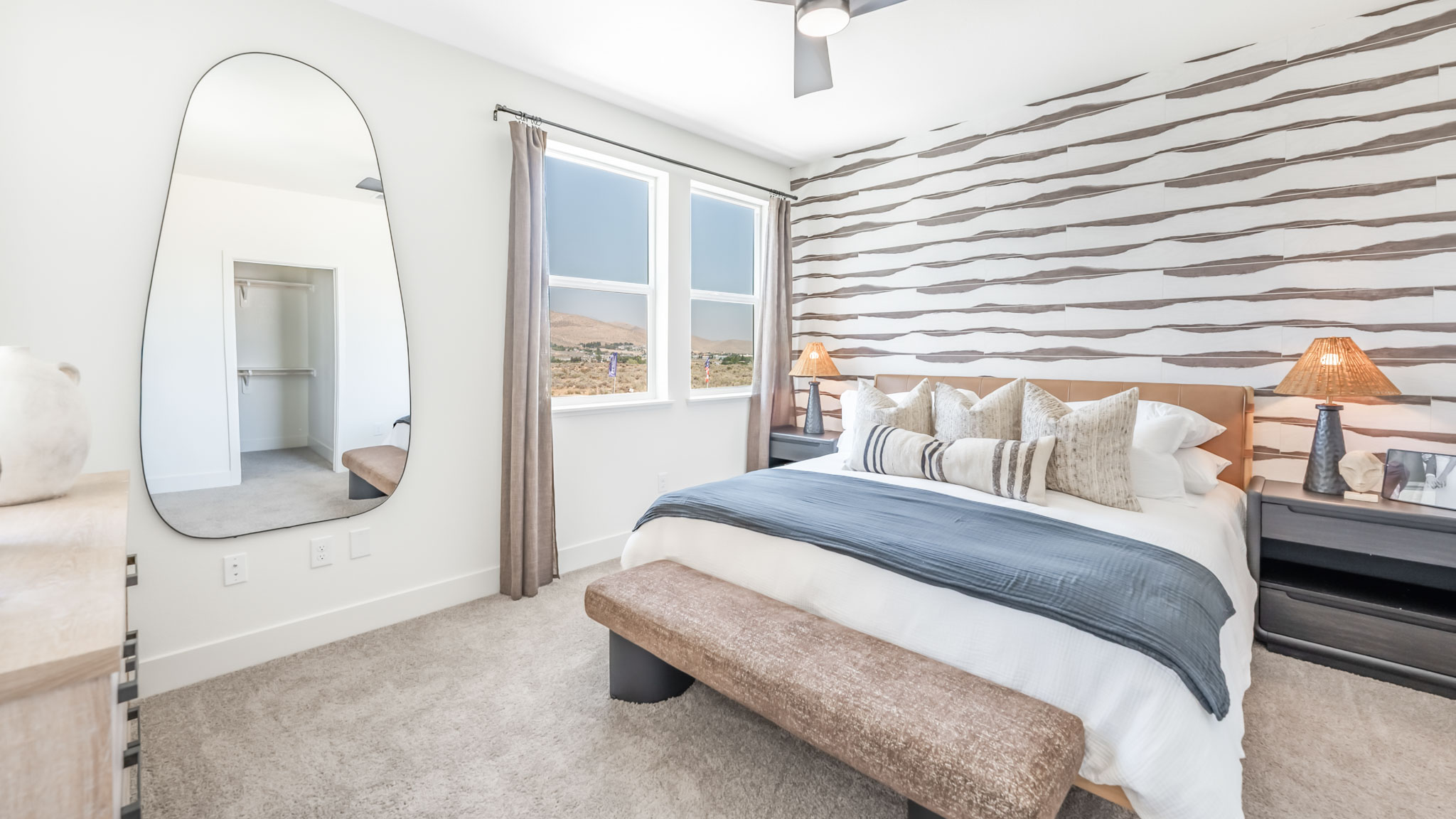 Bright primary bedroom with a large window
