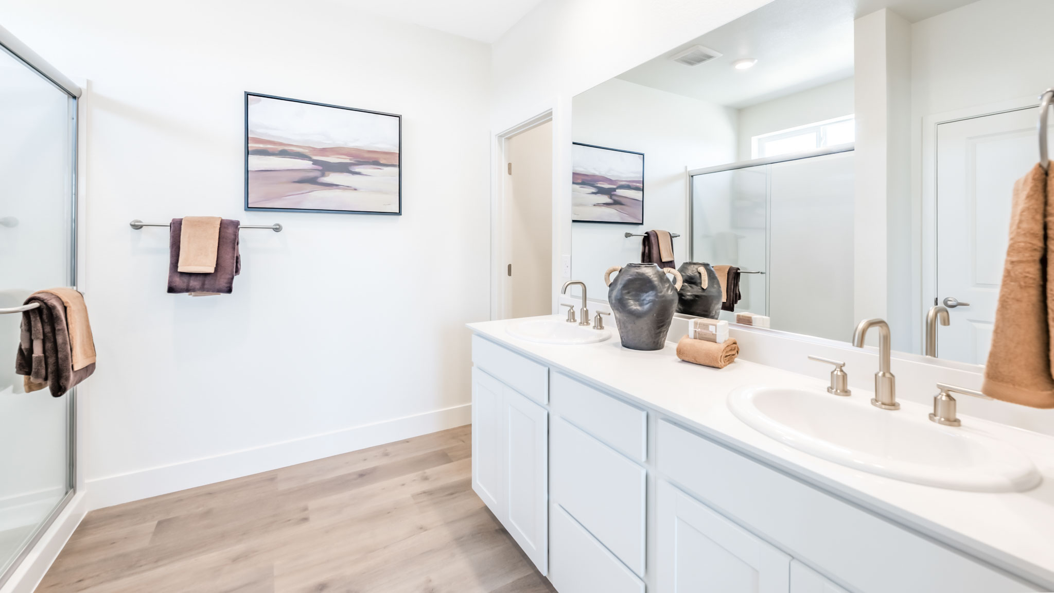 Primary bathroom with a double vanity and walk in shower