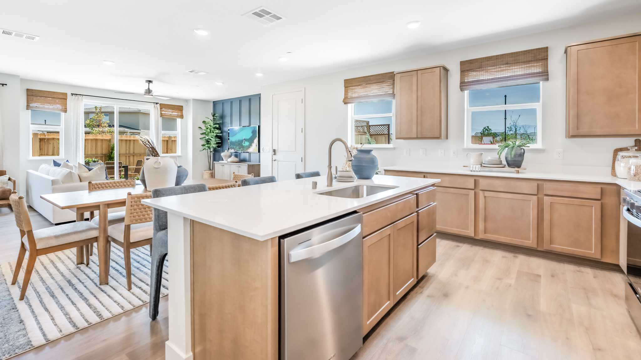 Kitchen island with a dishwasher and large window to let light in