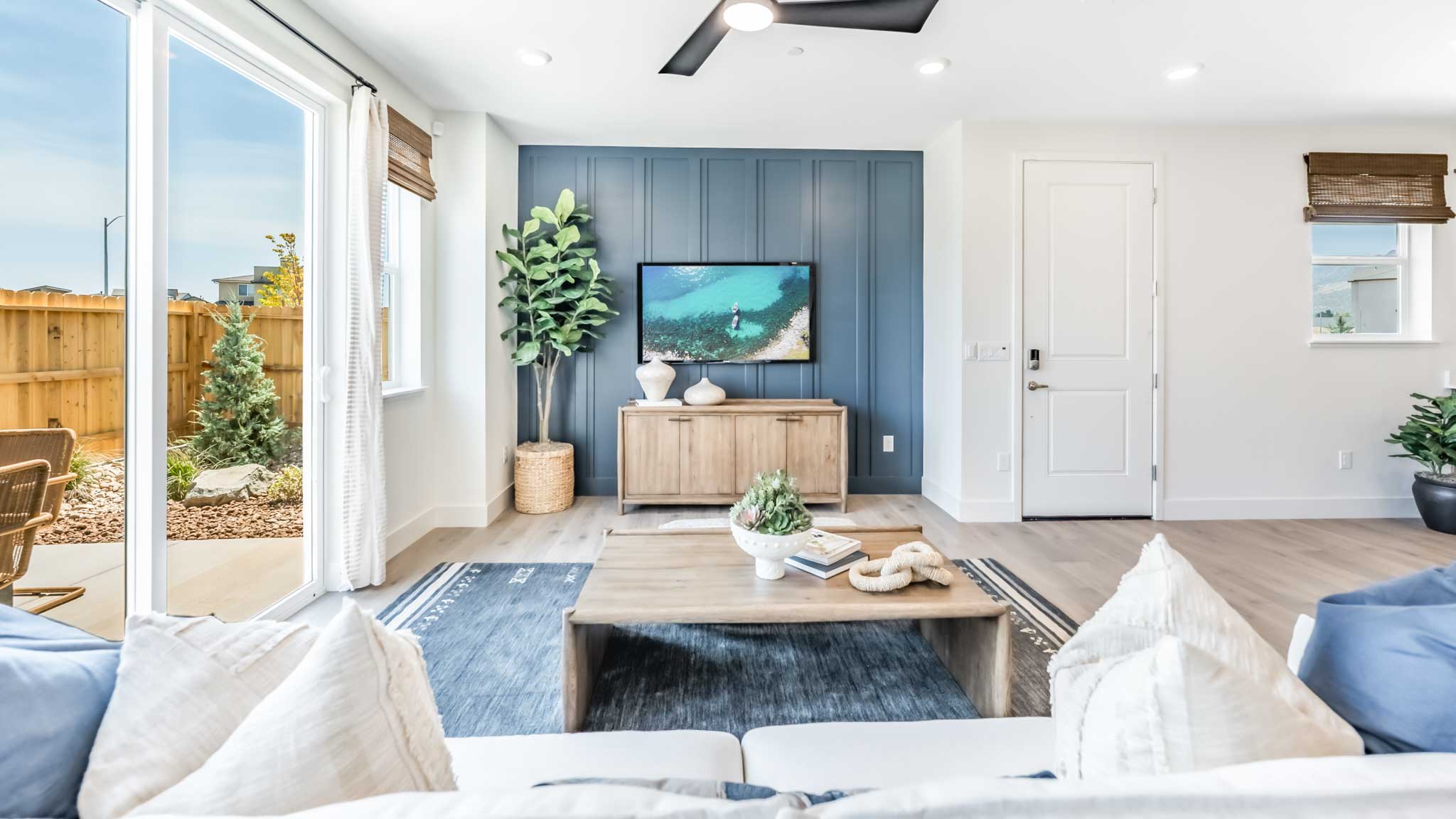 Bright open concept great room with a blue accent wall