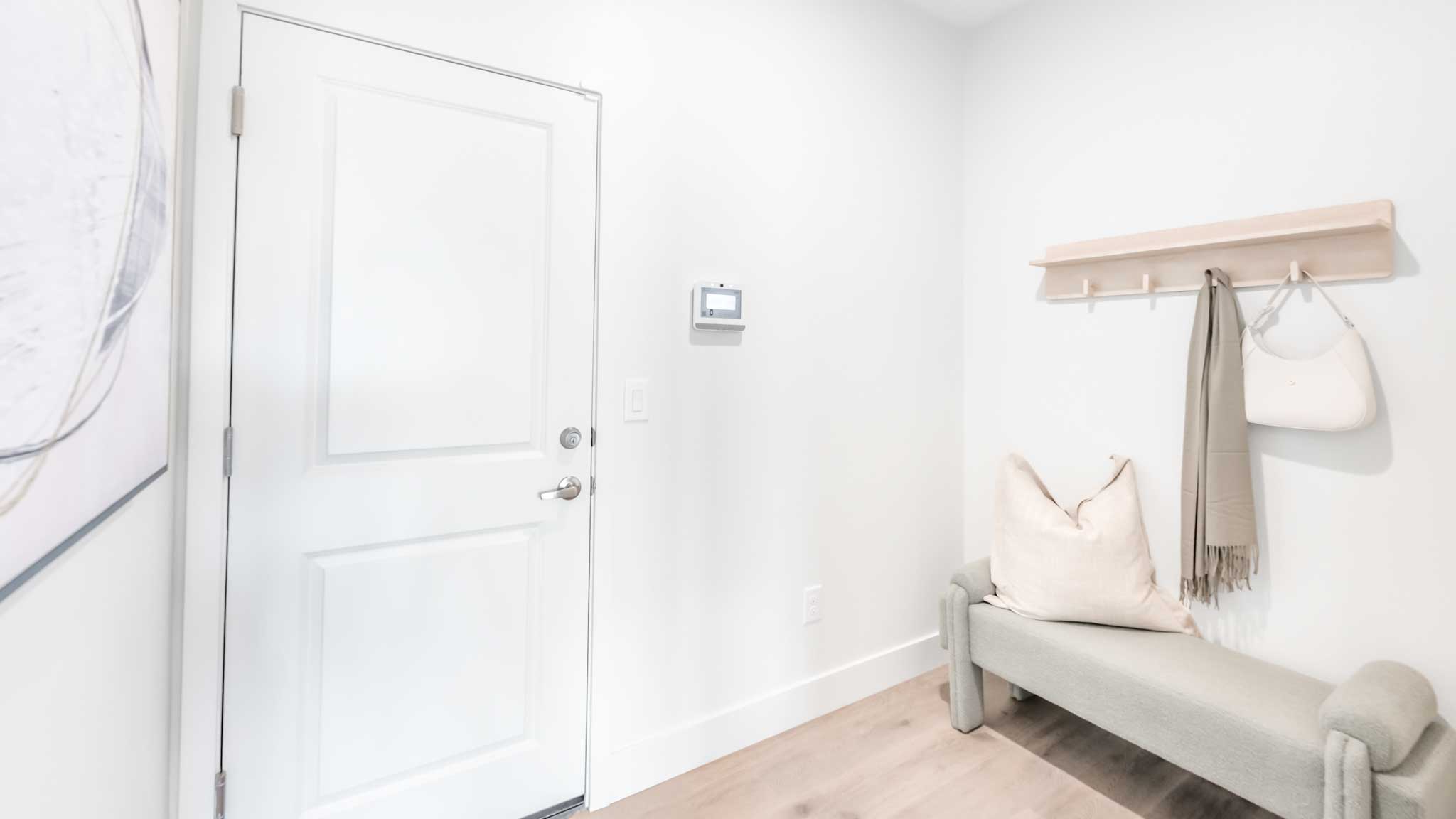 Mud room off the garage with a bench