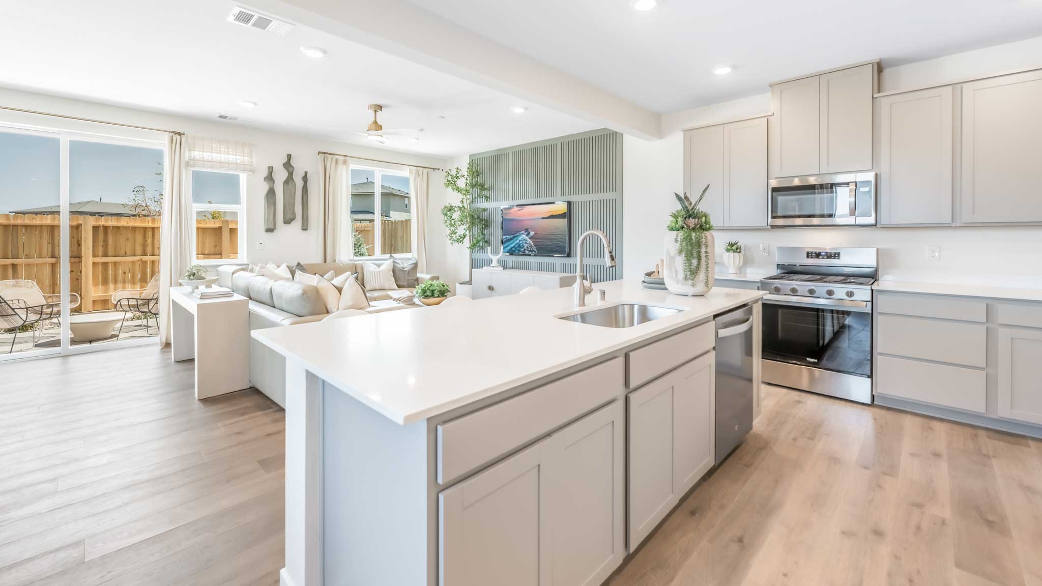 Large kitchen island looking towards the living room and sliding door