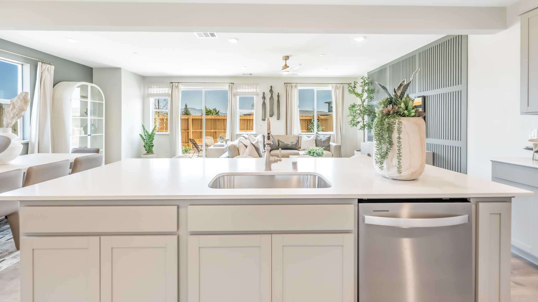 Kitchen island with a single basin sink and dishwasher