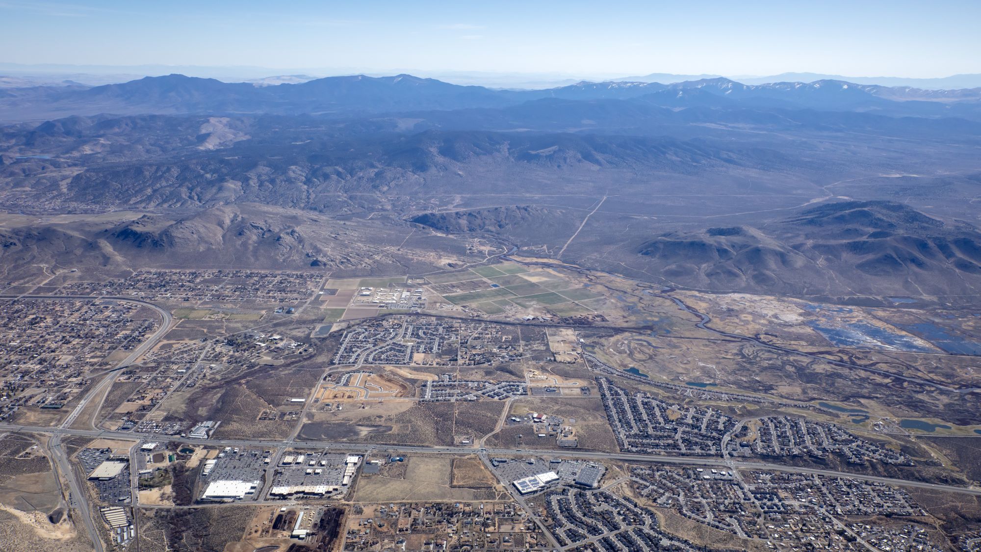 Aerial of Carson City with mountains in the background