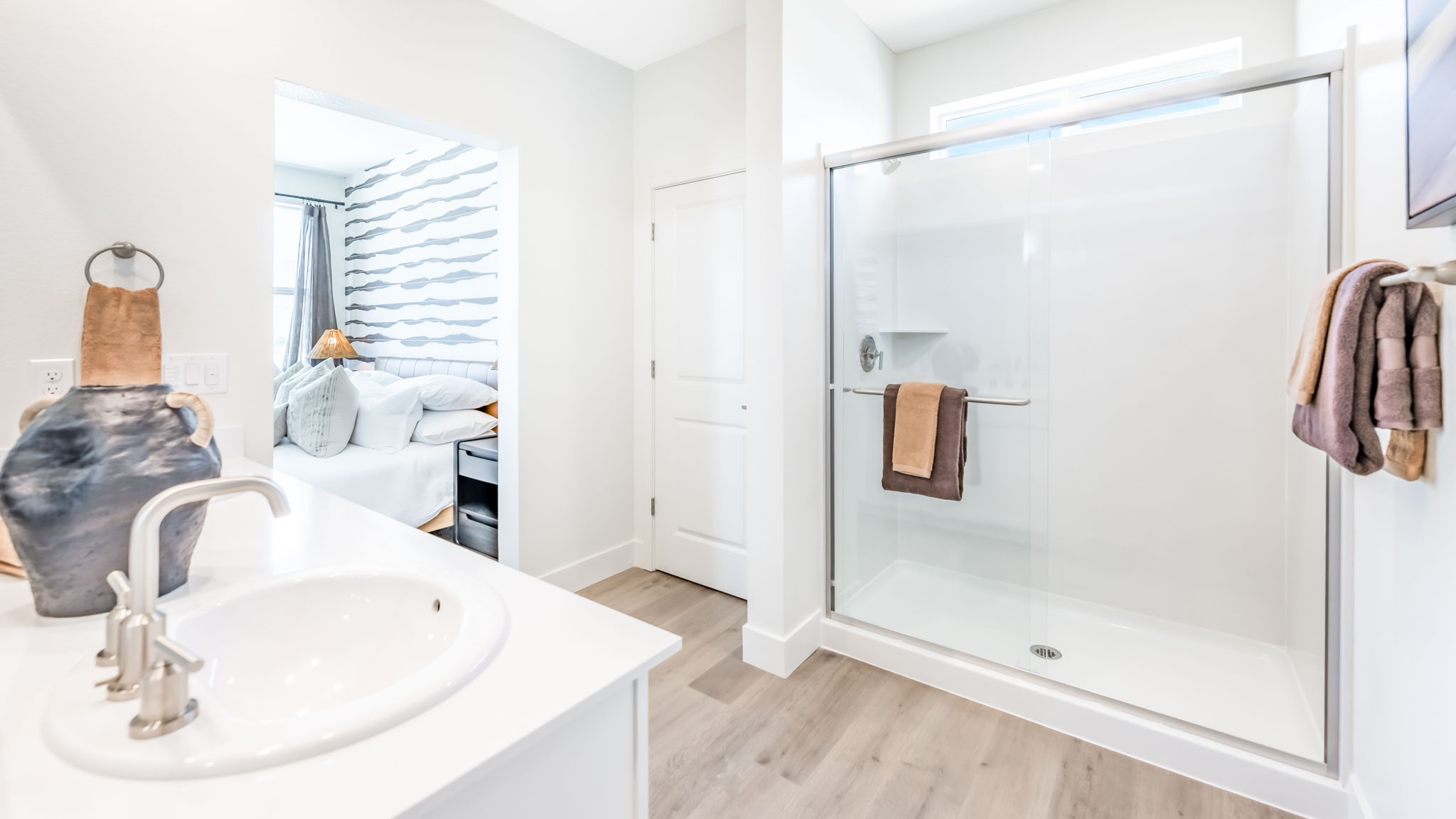 Primary bathroom with a double vanity and walk in shower