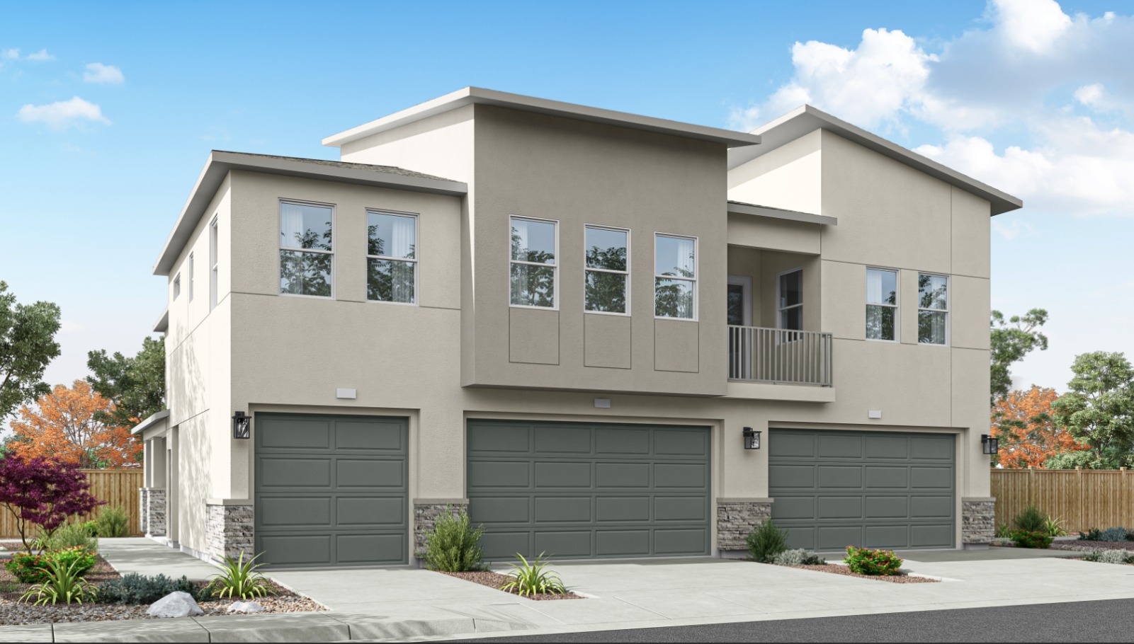 Rendered photo of the back of a three plex with garages