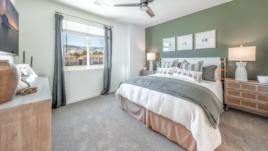 Primary bedroom with carpeted floor and attached bathroom