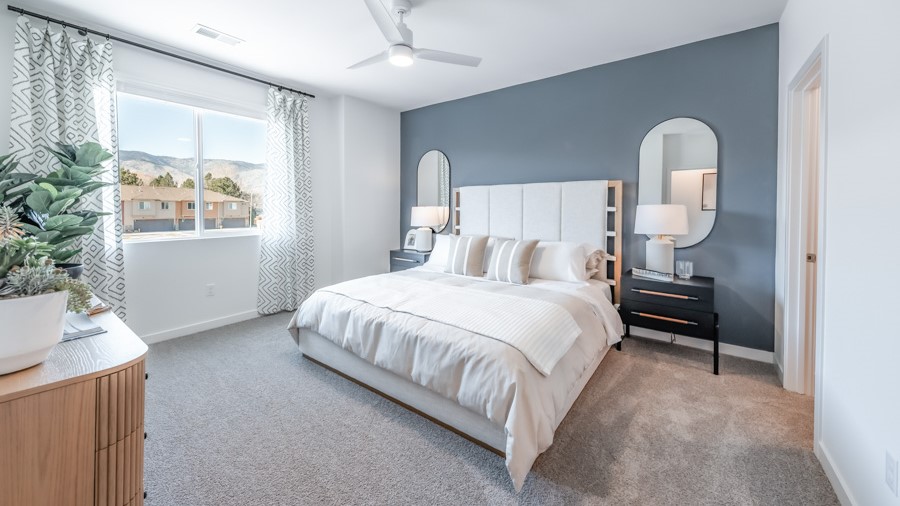 Primary bedroom with carpeted floor and attached bathroom