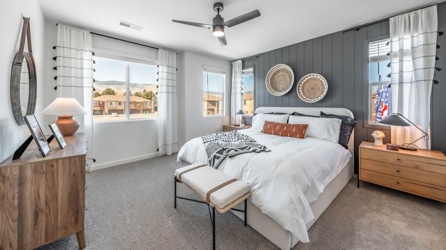 Primary bedroom with carpeted floor and attached bathroom