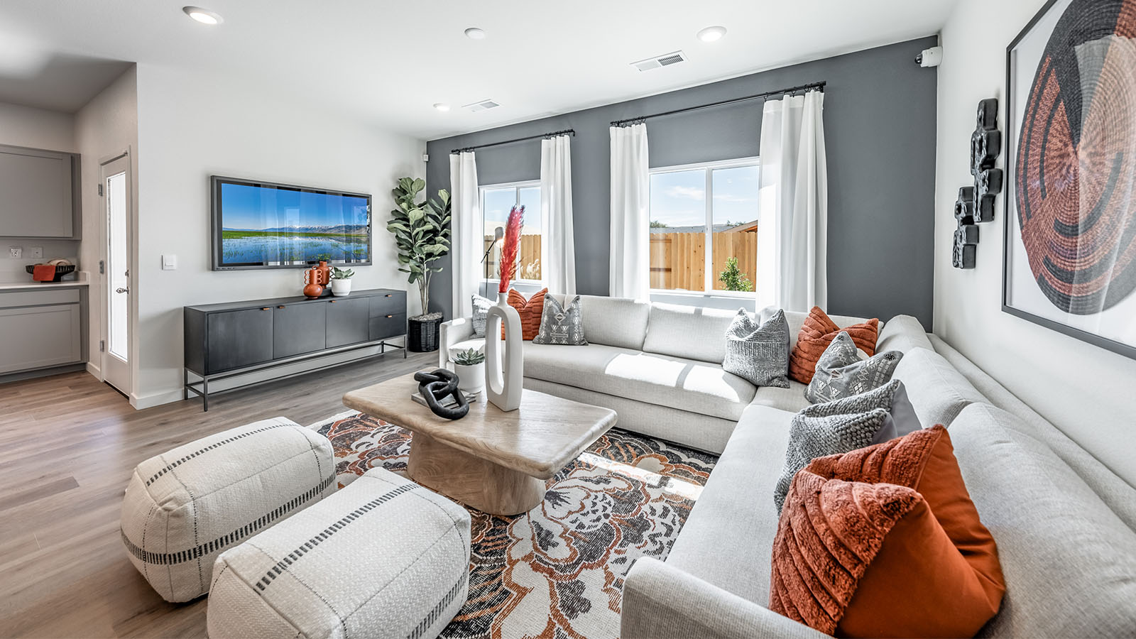 Bright and modern living room area with room for a sectional
