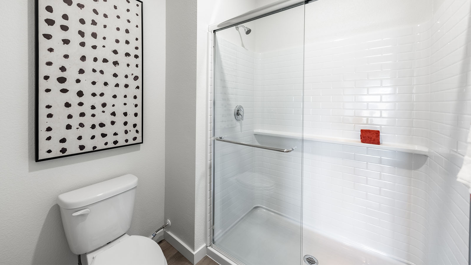 Walk-in shower and toilet in separate room in primary bathroom