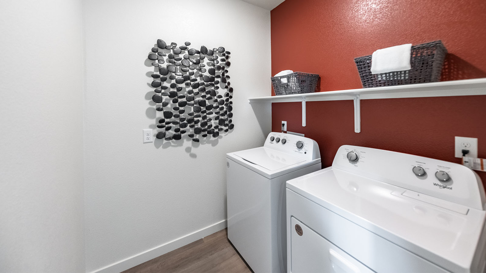 Separate laundry room with shelf above full-sized machines