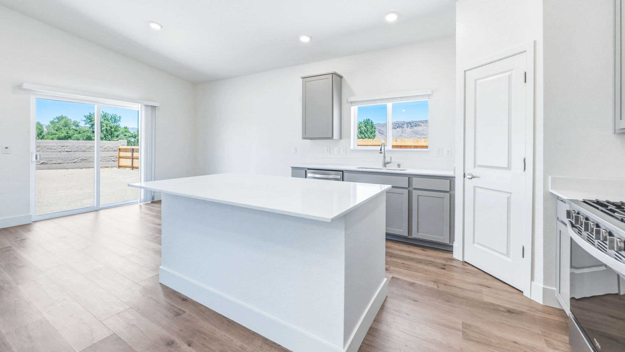 Bright kitchen with an island and sliding backyard door