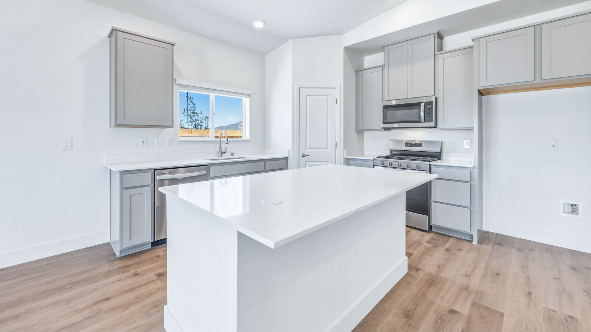 Island with modern cabinets and stainless steel appliances