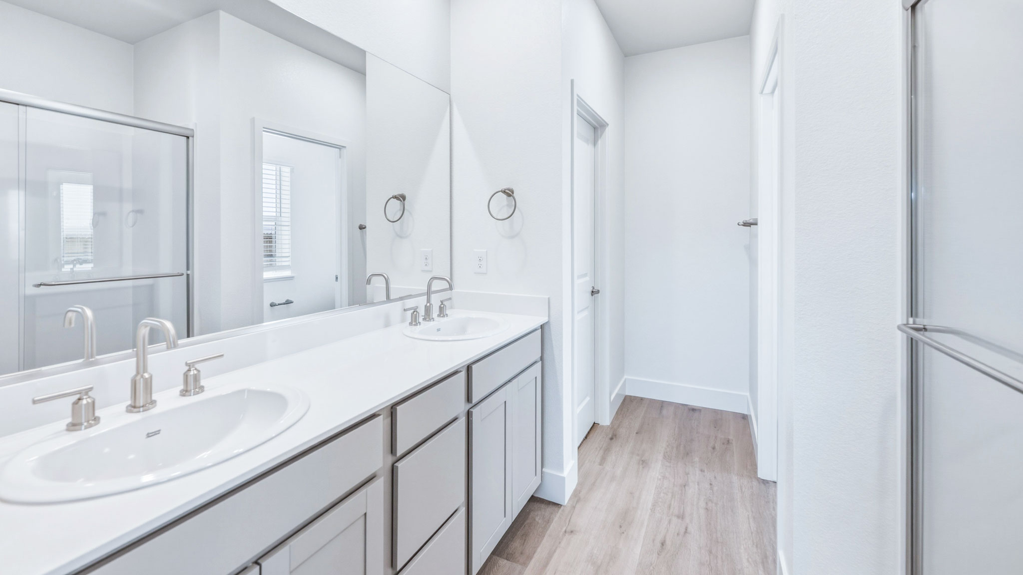 Primary bathroom with a dual vanity and walk in shower