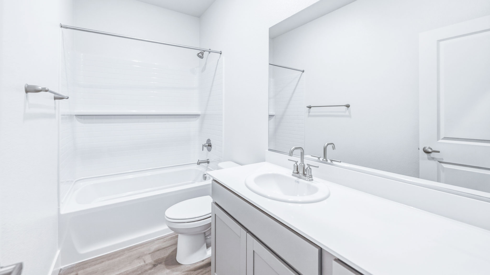 Secondary bathroom with vanity, toilet, and shower tub combo