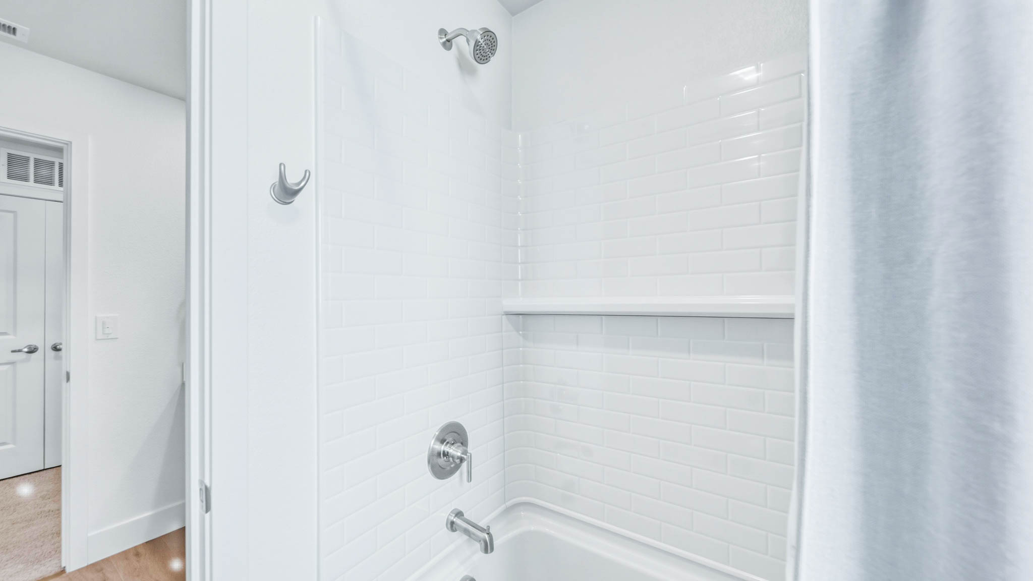 Secondary bathroom with a shower tub combo