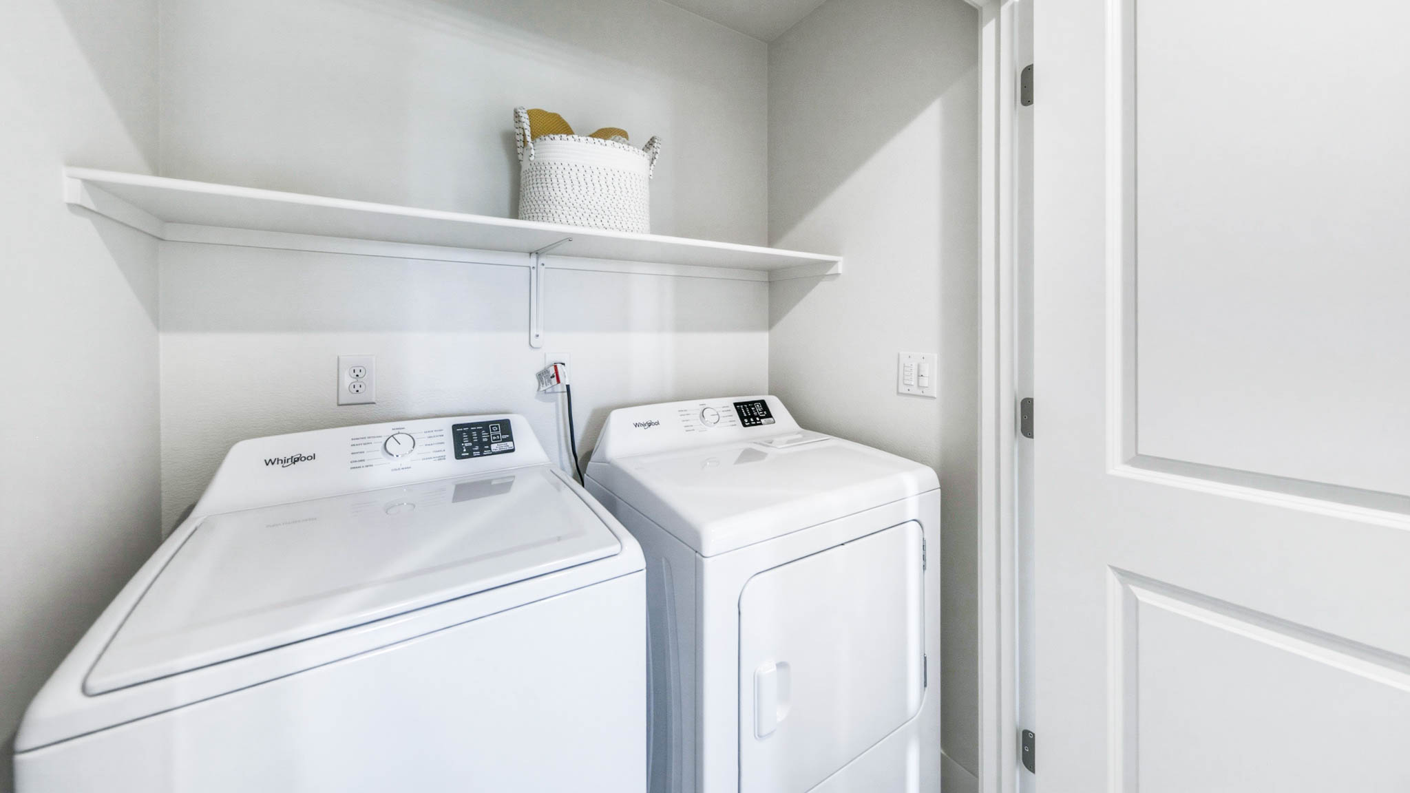 Laundry room with shelving and a bright window