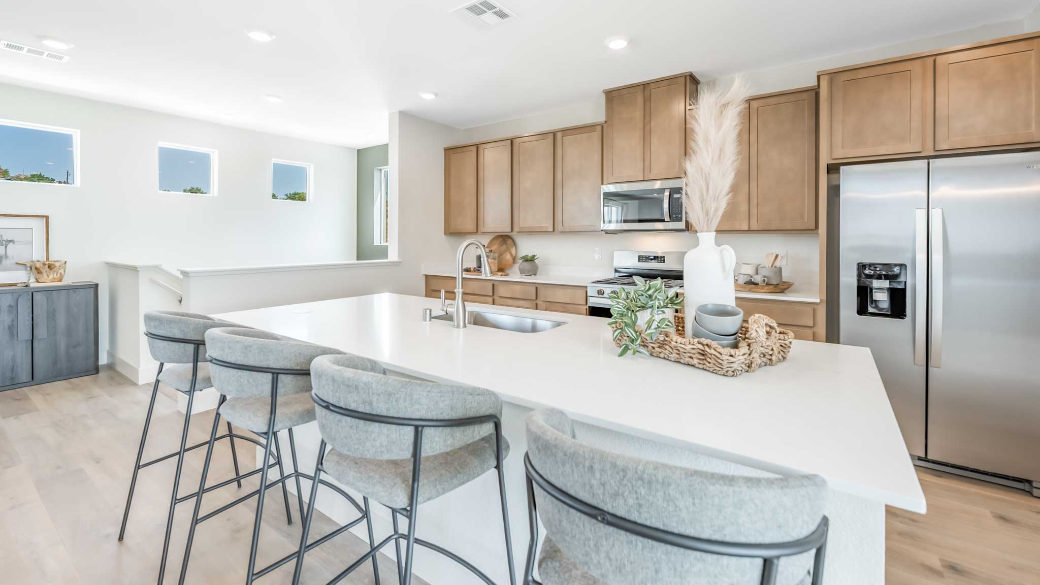 Large kitchen island facing the cabinets and appliances