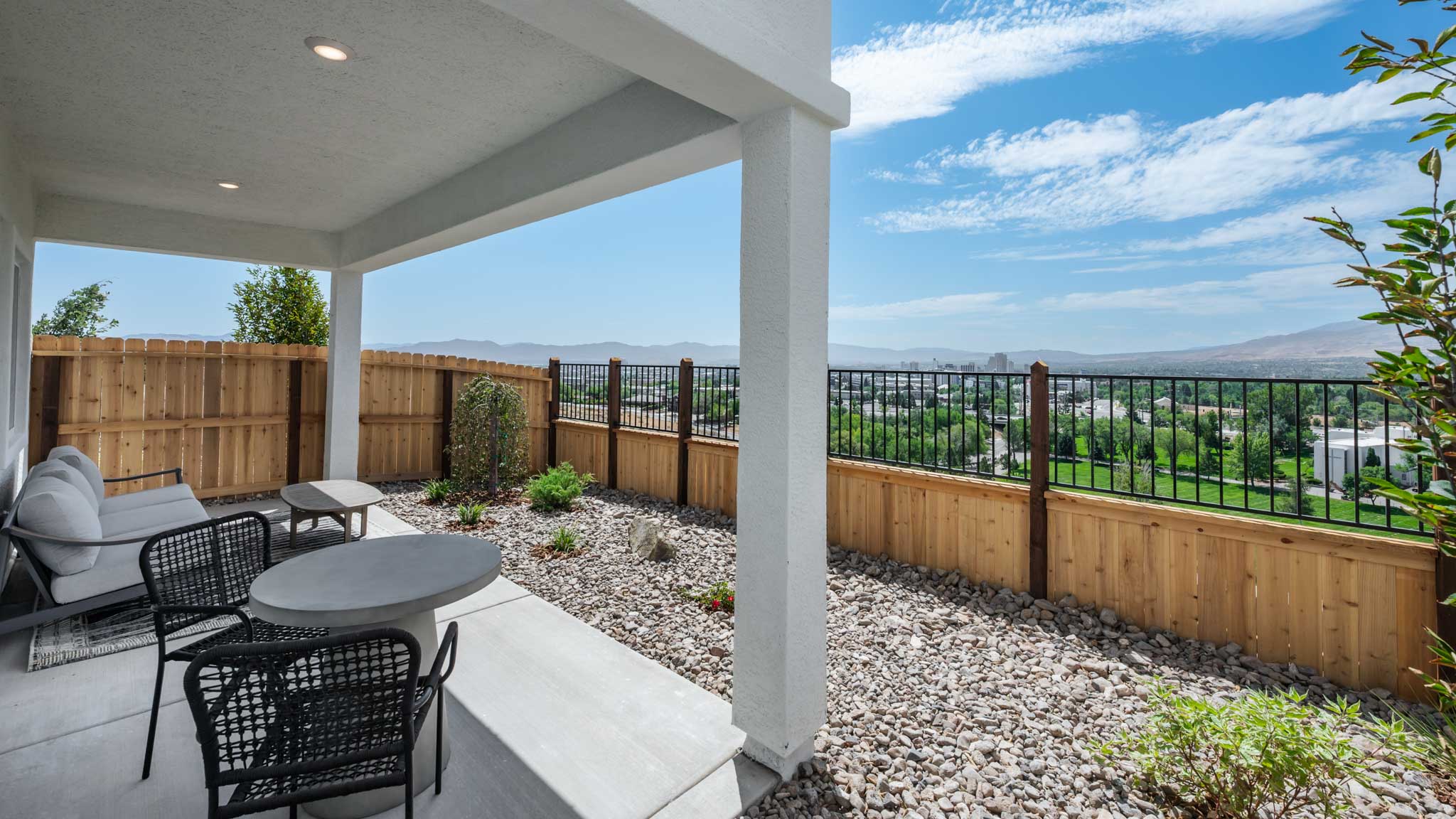 Landscaped backyard with a covered patio