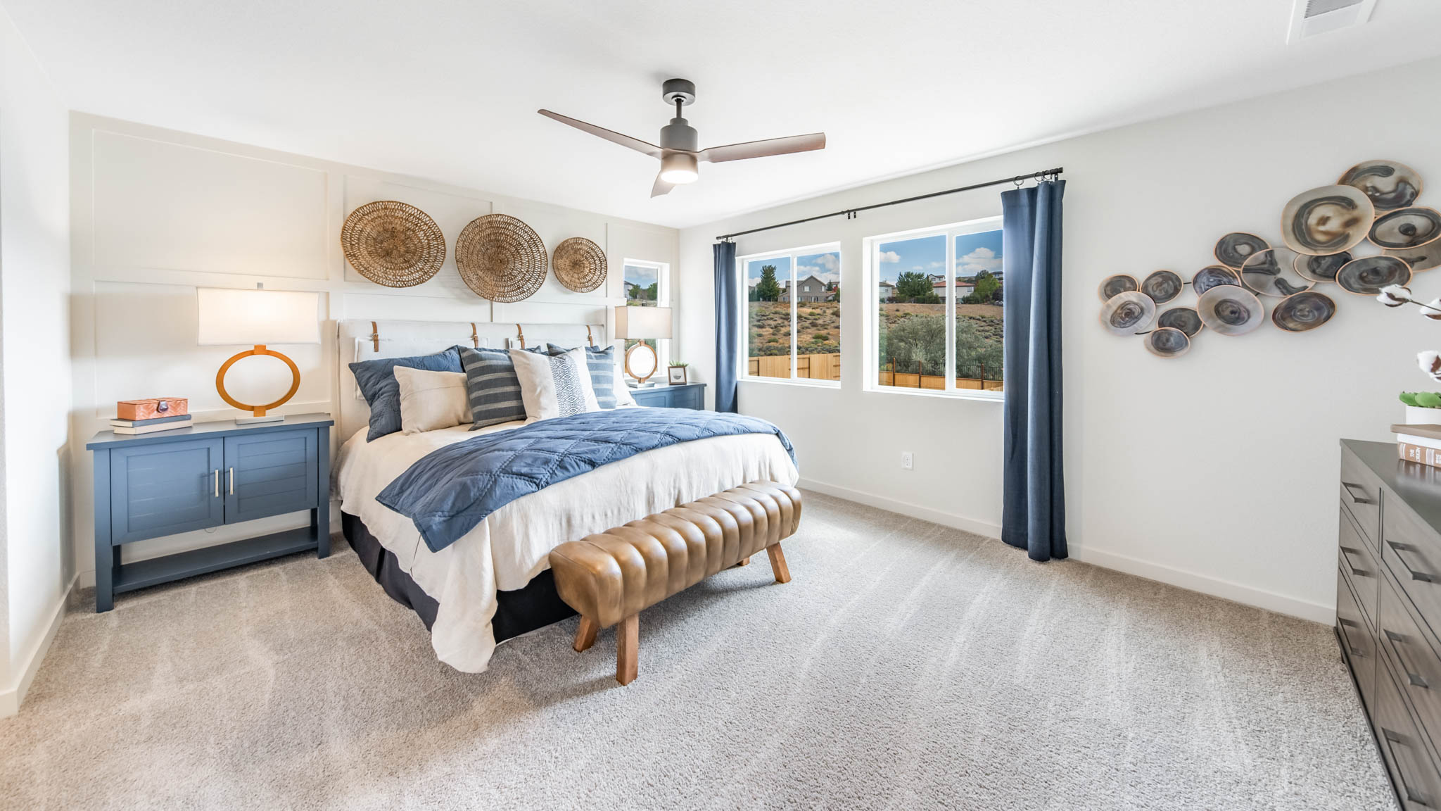 Bright primary bedroom with large windows